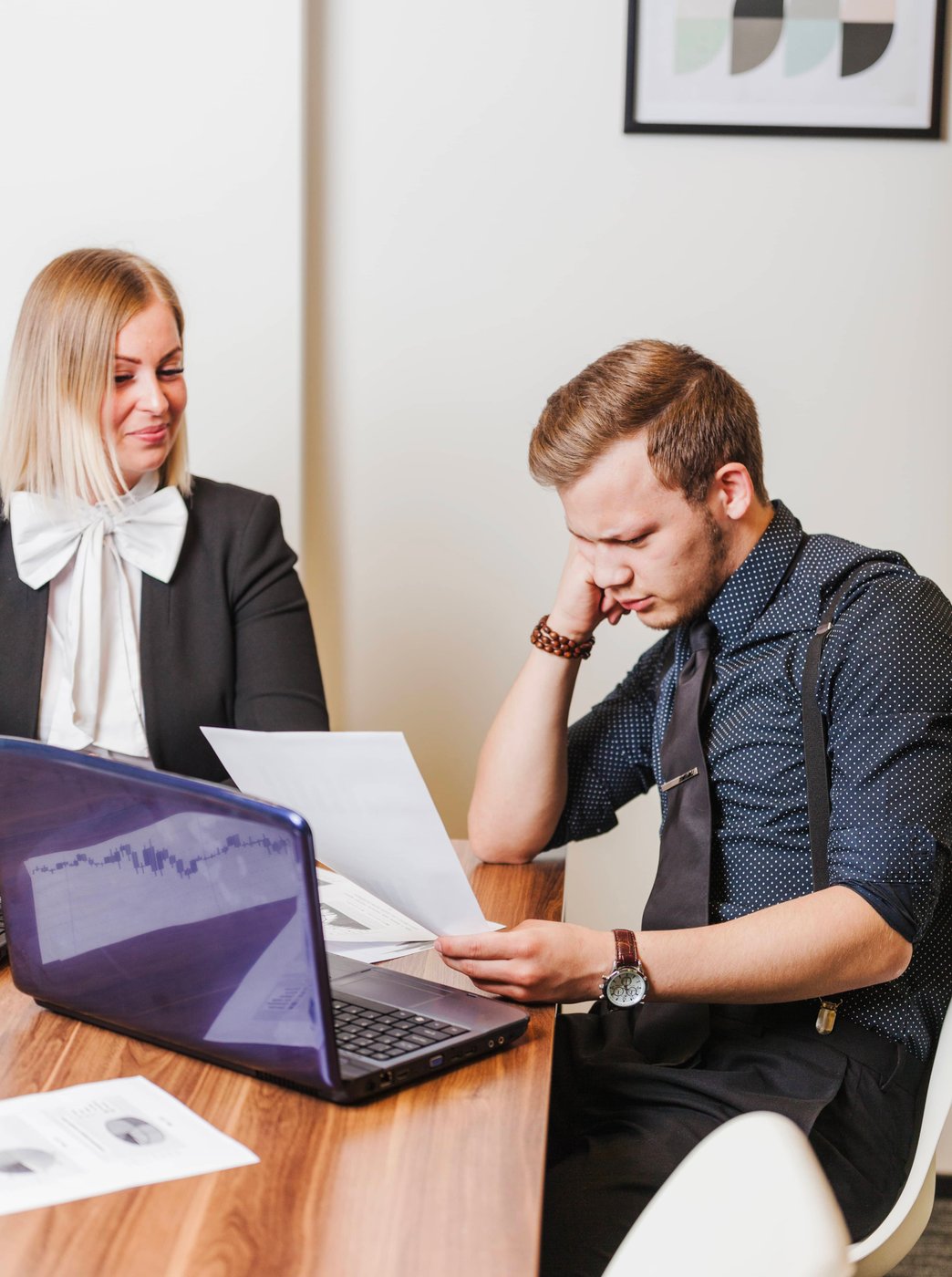 Lawyer reviewing documents with clients in office