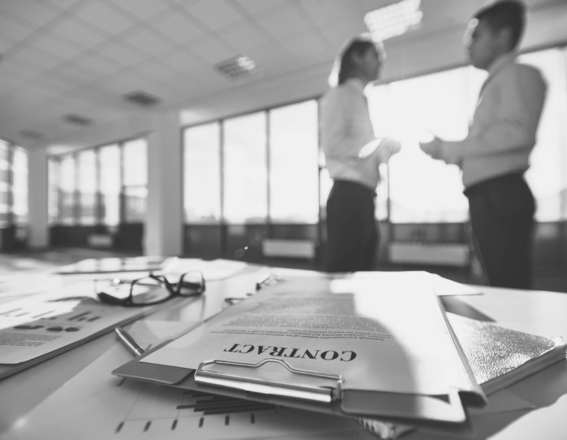 Legal documents and contract paperwork on desk